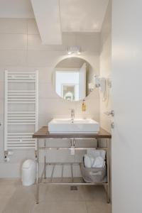 a bathroom with a sink and a mirror at Rogač Rooms & Restaurant in Omiš