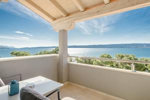 a balcony with a view of the water at Rogač Rooms & Restaurant in Omiš