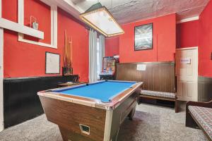stół bilardowy w pokoju z czerwonymi ścianami w obiekcie Willin House Hotel w Blackpool