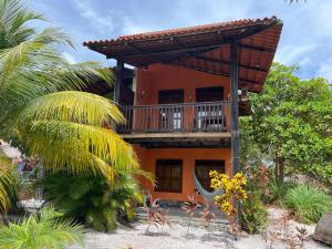 a house with a balcony on the beach at Ecolodge Batel Alagoas in Coruripe