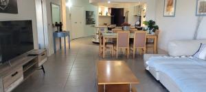 a living room with a couch and a table at Sunkissed at 1770 in Agnes Water