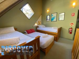 a bedroom with two beds and a skylight at Mitta Mitta in Thredbo