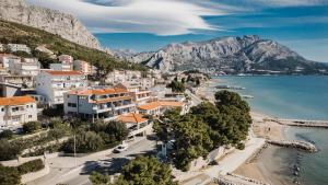 a view of a town next to the water at Rogač Rooms & Restaurant in Omiš