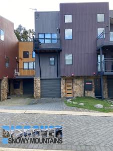 a large apartment building with a parking lot at Aspen Creek 3 in Thredbo