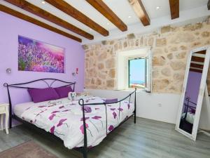 a bedroom with a bed and a window at Holiday house with a parking space Babino Polje, Mljet - 22324 in Babino Polje