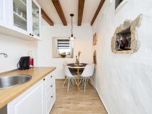 a kitchen with a table and a dining room at Holiday house with a parking space Babino Polje, Mljet - 22324 in Babino Polje