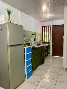 a kitchen with a refrigerator and a counter top at Casa Irene in Orotina