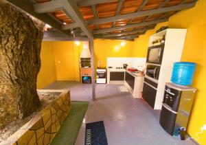 a kitchen with a tree in the middle of it at Suíte Luxo contêiner no Caçari in Boa Vista