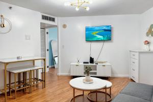 a living room with a kitchen and a table at 1BR Ocean Sunset View With Parking in Honolulu