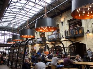 a group of people sitting at tables in a restaurant at New Listing Cozy Downtown Loft Rooftop Patio BBQ Gym Coffee in Winnipeg