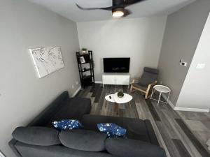 a living room with a couch and a tv at Premium 2-bed Condo Uptown Saint John Parking Coffee Location in Saint John