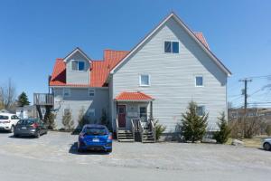 a large house with cars parked in front of it at Amazing location in Saint John 2 Br Modern Parking New in Saint John