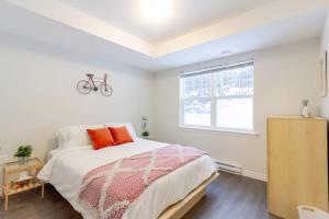 1 dormitorio con cama y ventana en New 2BD Condo, UNB, Hospital, Golf, Patio Coffee, en Saint John