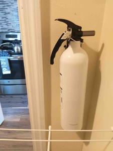 a white fire hydrant in the corner of a room at C & N Lodging in Bluffton