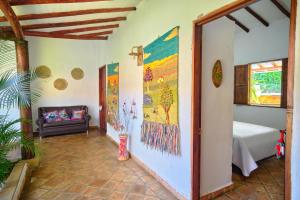 a hallway with a room with a bed and a couch at Hostal Sueño Real Campestre in San Gil
