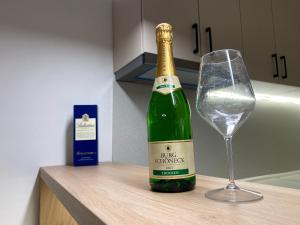 a bottle of champagne and a wine glass on a counter at FIA HOUSE Kozle in Ždanec