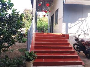 a set of red stairs with a motorcycle on it at Đức Phát Homestay in Tân Phú