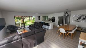 a living room with a couch and a table at Dewdrop Cottage in Hastings