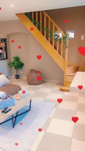 a living room with a staircase and hearts on the floor at Les Almadies private Jacuzzi in Villeneuve-les-Sablons