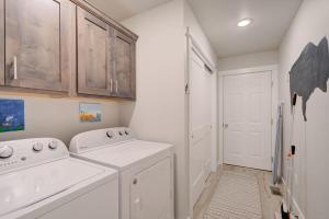a white laundry room with a washer and dryer at Mountain View Haven in Belgrade in Belgrade