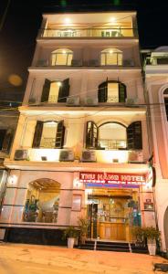 a large white building with a sign in front of it at Thu Hang Sapa Hotel - by Bay Luxury in Sa Pa