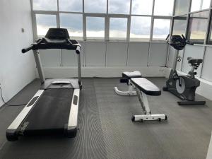 a gym with a treadmill and two exercise bikes at In the heart of Colombo 2 Bedrooms Apartment in Colombo