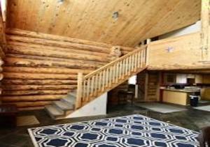 a room with a staircase and a wooden ceiling at Log Haven in Blanding in Blanding