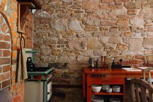 a stone kitchen with a counter and a stone wall at The Old Clarence Brewery in Maclean +58 photos