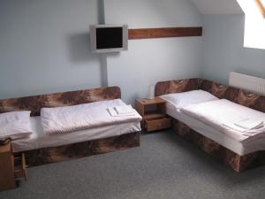 เตียงในห้องที่ Sudický Dvur