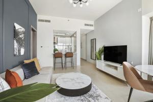 a living room with a couch and a table at Silkhaus Al Reem island Modern 1BDR in Abu Dhabi