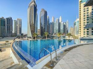 a large swimming pool in a city with tall buildings at Silkhaus Ideal for Big Family, 5BDR with Private Roof Top in Dubai