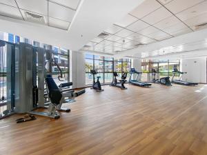 a gym with treadmills and exercise equipment in a building at Silkhaus new studio in Art Gardens pool access in Dubai