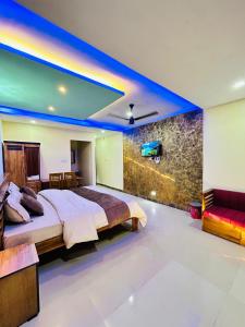 a bedroom with a bed and a tv on a wall at Greenview in Vythiri