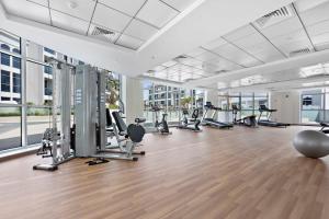 a gym with treadmills and exercise equipment in a building at Silkhaus beautiful studio in Art Gardens with pool access in Dubai