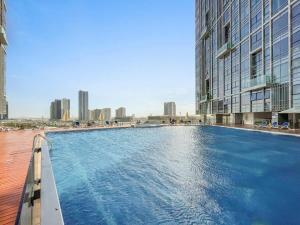 a large swimming pool in the middle of a city at Silkhaus High Floor 1 BDR Al Fay Park Nearby in Abu Dhabi