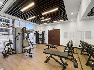 a gym with treadmills and exercise equipment in a room at Silkhaus Spacious 2 BDR Reem Central Park Nearby in Abu Dhabi