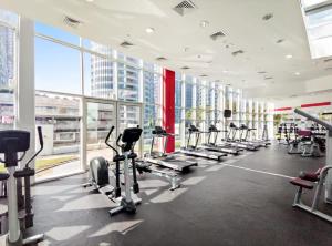 a gym with a lot of treadmills and machines at Silkhaus Beautiful Studio Reem Park nearby in Abu Dhabi