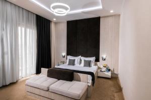 a bedroom with a king sized bed and a couch at Art Regency Premium Hotel, Free Airport Shuttle Service in Tashkent +109 photos