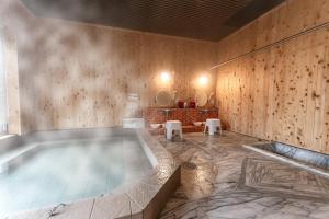 a swimming pool in a room with wooden walls at 完全貸切別荘 天然温泉 La Saison inn Kirishima 888 in Kirishima