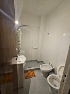 a bathroom with a toilet and a sink at 3 Ambientes frente al Golf - Playa Grande in Mar del Plata