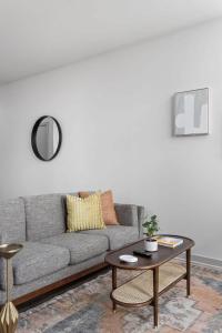a living room with a couch and a table at CozySuites l Lavish 1BR, Bottleworks Indy #4 in Indianapolis