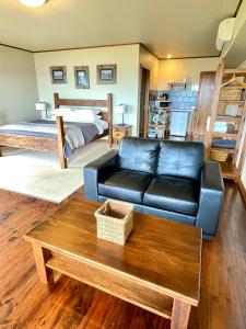 a living room with a couch and a bed at Castaways Apollo Bay in Apollo Bay