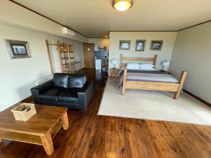 a living room with a bed and a couch at Castaways Apollo Bay in Apollo Bay