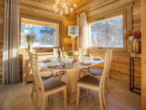a dining room with a wooden table and chairs at Chalet La Clusaz, 4 pièces, 6 personnes - FR-1-304-287 in La Clusaz