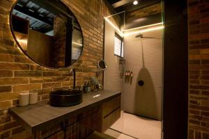 een badkamer met een wastafel en een spiegel bij Hotel Meridiano Lofts in Medellín