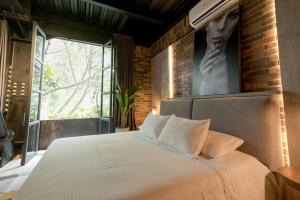 Postel nebo postele na pokoji v ubytování Hotel Meridiano Lofts