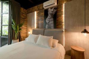 Postel nebo postele na pokoji v ubytování Hotel Meridiano Lofts