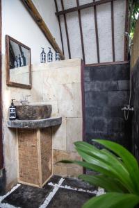 a bathroom with a sink and a mirror at Villa Bagus in Gili Air