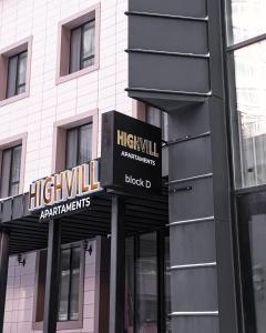 a building with two signs on the front of it at HIGHVIL APARTAMENTS in Astana