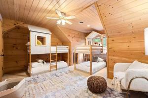 a bedroom with two bunk beds in a cabin at Book For Summer Now! • Pool • Gameroom • Firepit • in Arden